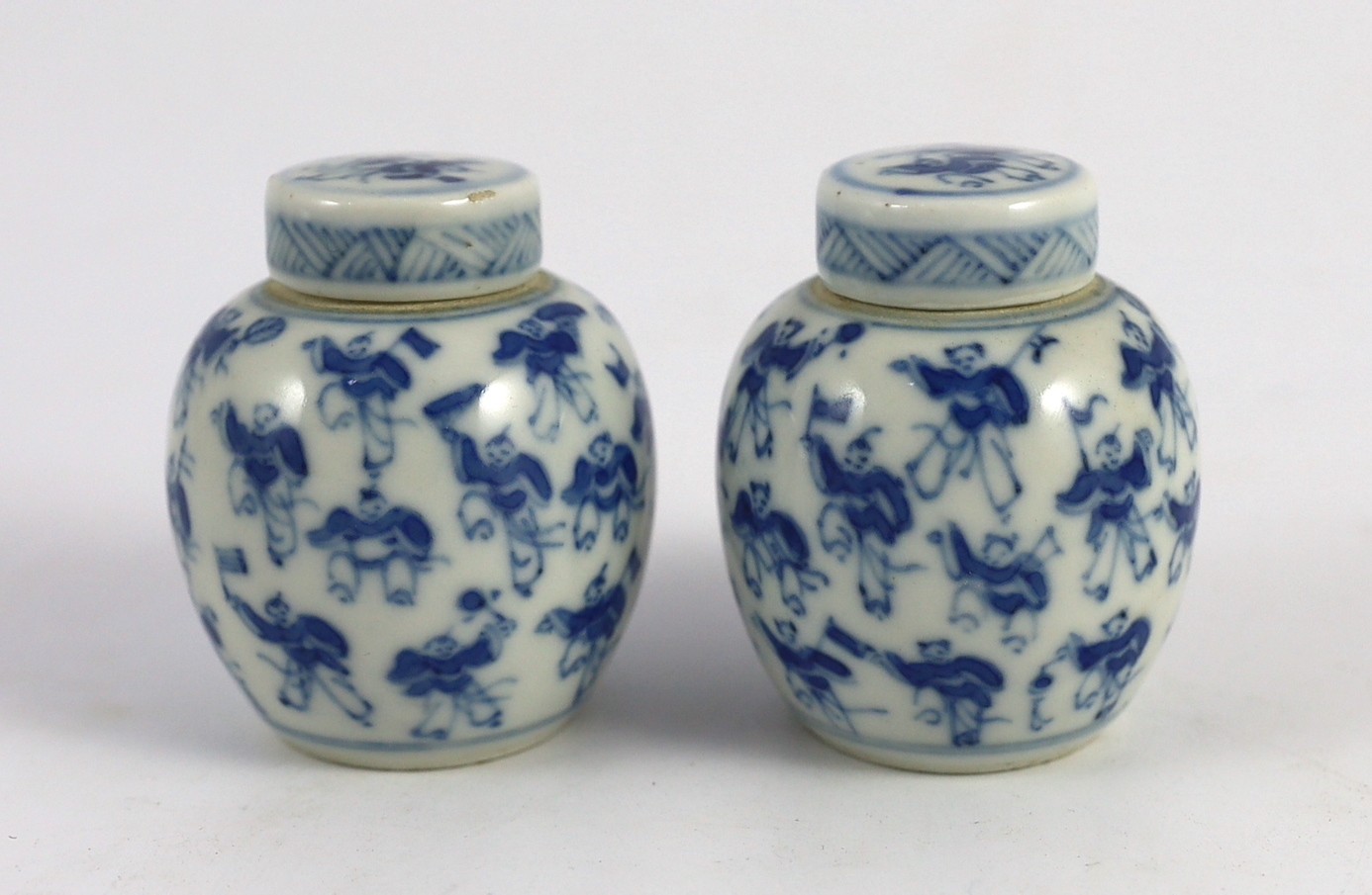 A pair of 19th century Chinese blue and white boys miniature jars and covers, 5.5 cm high